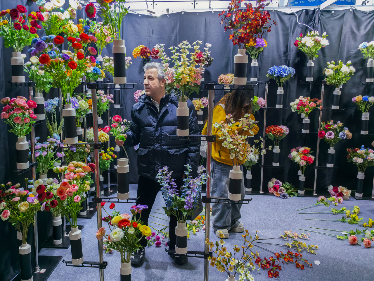 外商在展会现场挑选仿真花产品。主办方供图